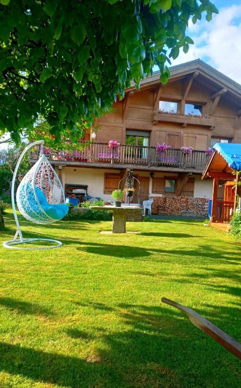 a house with a yard with a playground at Le chalet de Julbert in Combloux