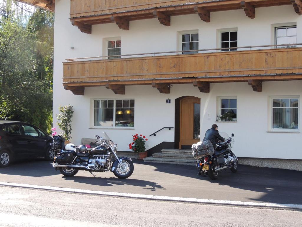two motorcycles parked in front of a building at Pension Rosenhof in Brixen im Thale