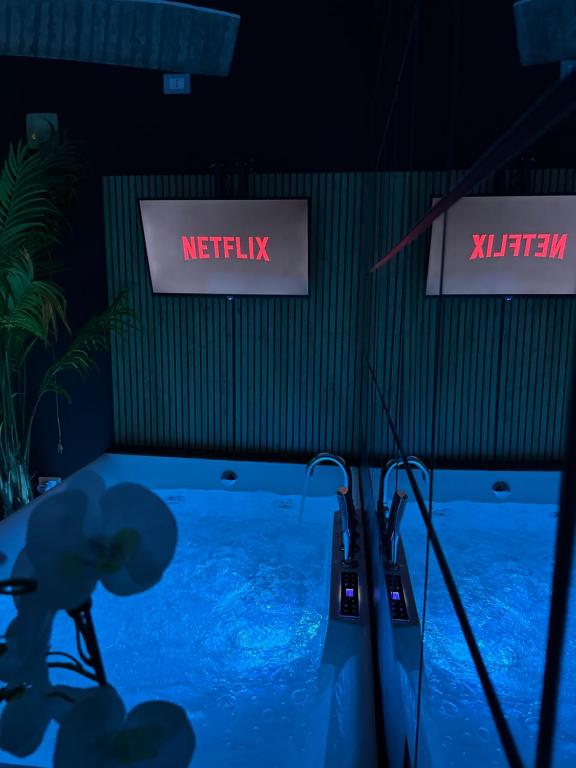 a swimming pool in a room with two signs at AMA Esclusive SPA Madama in Ferrara