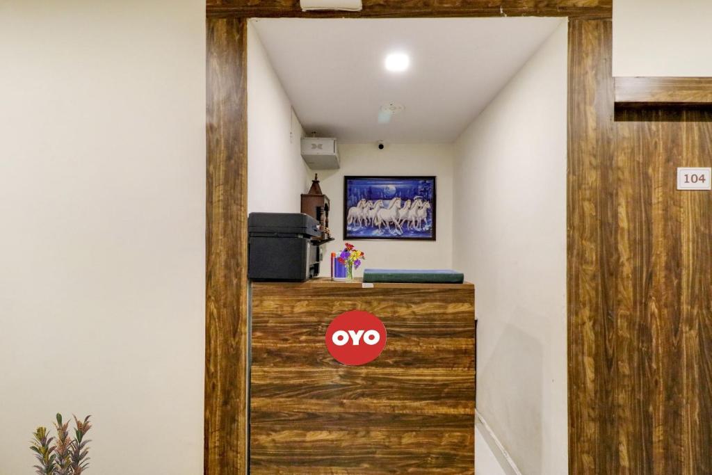 a room with a wooden door with a no sign on it at Hotel O Times Square in Indraprast