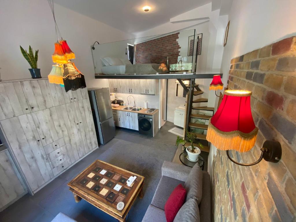 a living room with a couch and a red lamp at Sophia Loft Luxury Stay with Parking in Athens