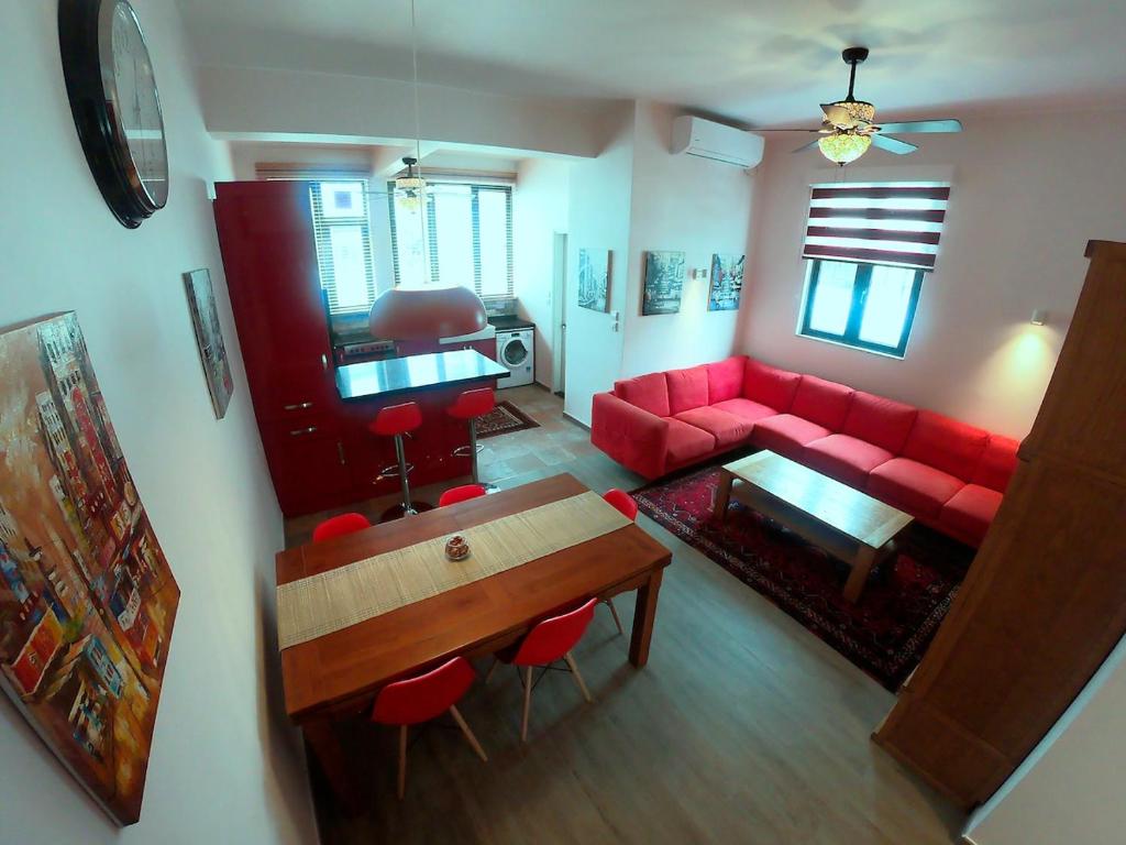 a living room with a red couch and a table at The Red House in Hong Kong