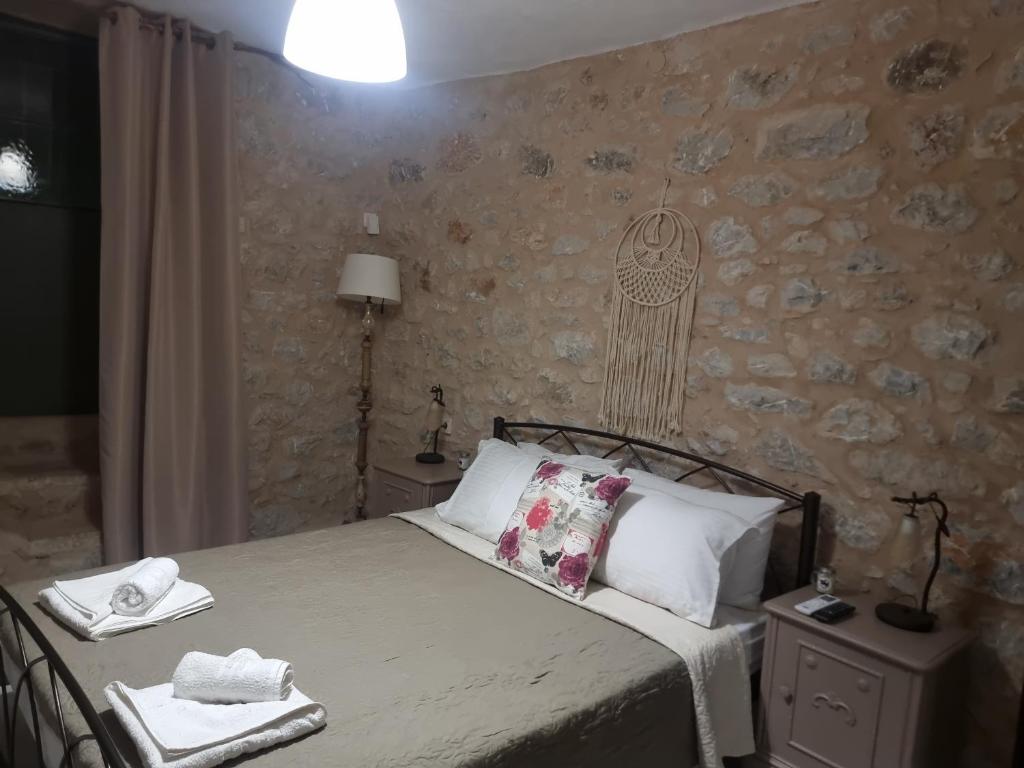 a bedroom with a bed with a pillow on it at Lagkadi Manis in Koíta