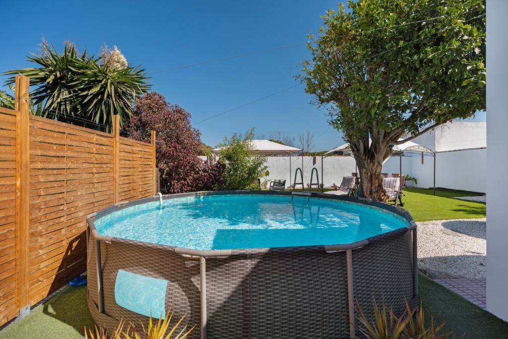 a swimming pool in a yard with a fence at Estudio Limón y Sal in Chiclana de la Frontera