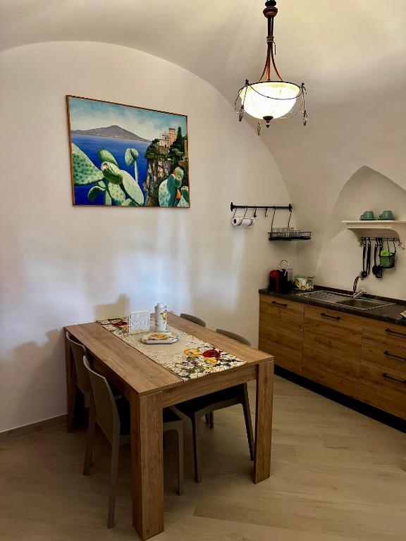 a kitchen and dining room with a wooden table at Casa Vacanza L'Aurora in Vico Equense