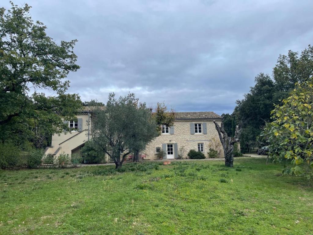 a large house with a yard in front of it at La bergerie in Grignan