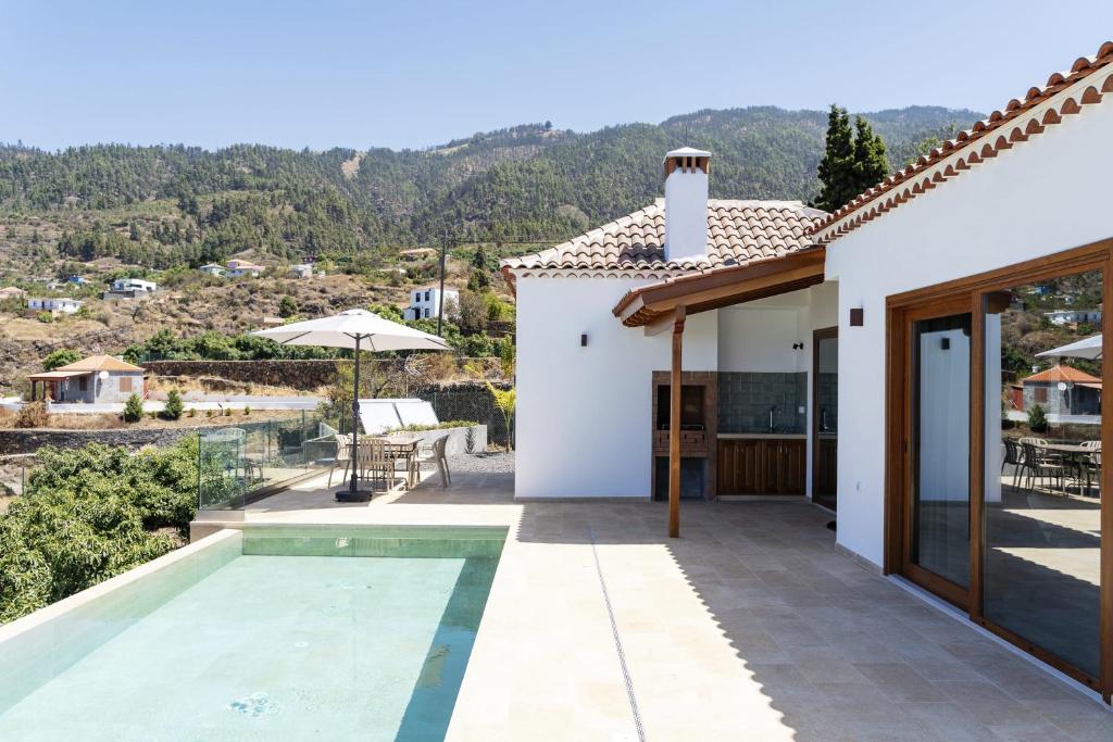 a villa with a pool and a view at Finca Tomasa in Tijarafe