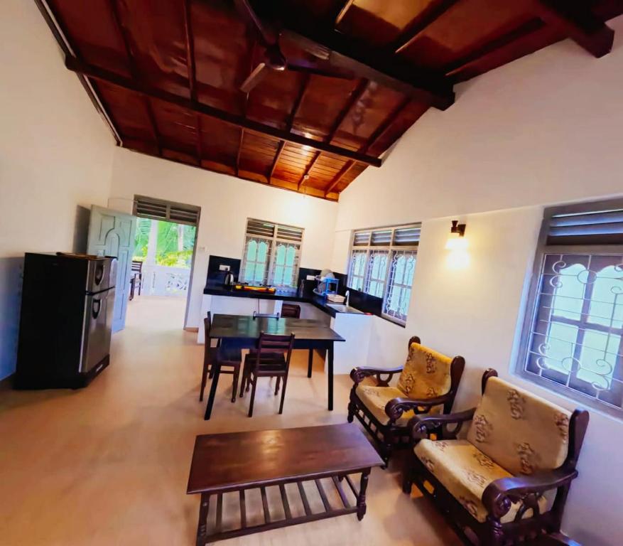 a living room with a table and chairs and a dining room at Susha Happy One First Floor Apartment in Hikkaduwa