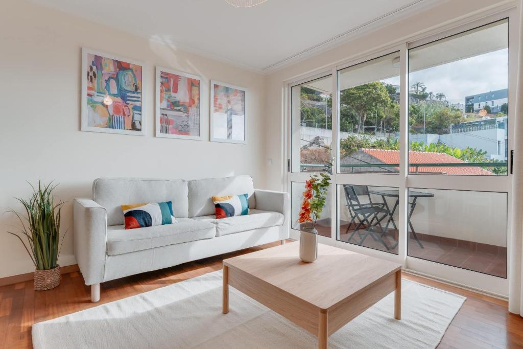 un soggiorno con un divano e un tavolo di Funchal City Nest a Funchal