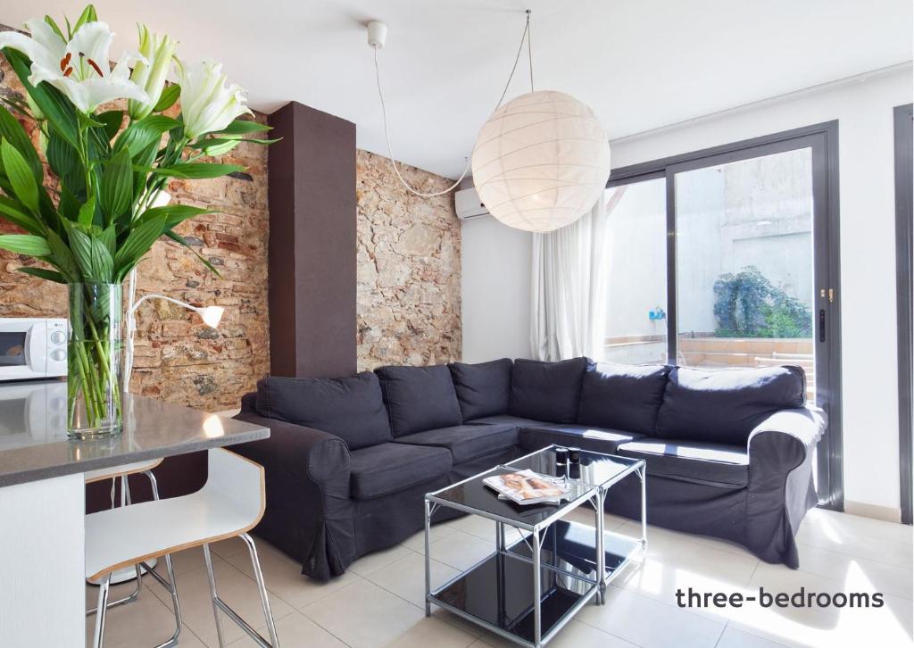 a living room with a blue couch and a table at Inside Barcelona Apartments Sants in Barcelona