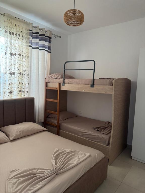 a bedroom with two beds and a bunk bed at Velipoja Dream Villa in Velipojë