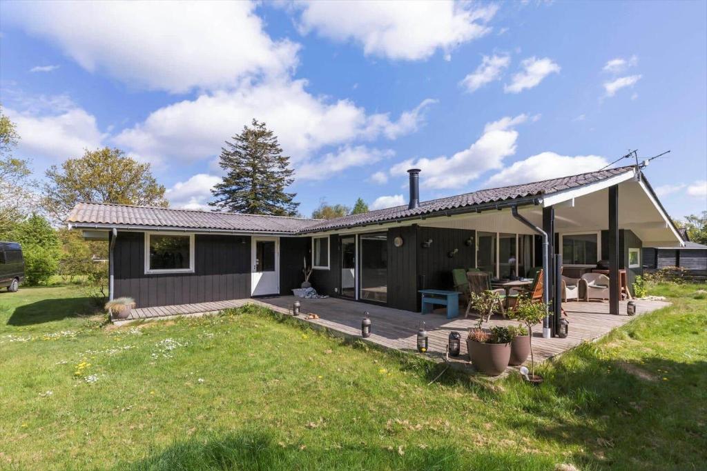 a house with a deck and a backyard at 8003-Knebel-Skodshovedgard-41 in Knebel