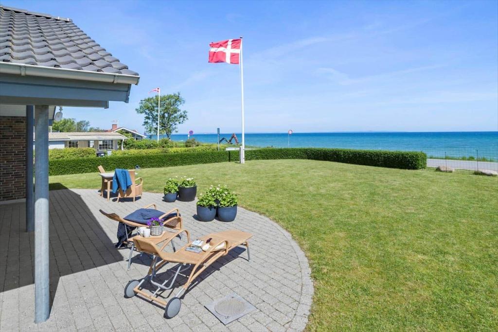 a patio with two chairs and a canadian flag at 30012-Malling-Peter-Eriksens-Vej-1 in Malling