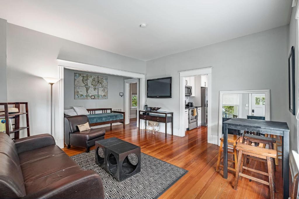 a living room with a couch and a table at Old City Charm l Historic l Walk to St George in Saint Augustine