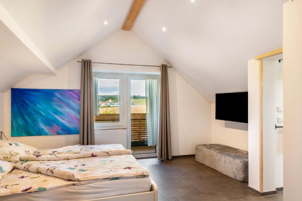 a bedroom with two beds and a flat screen tv at Pur Wohnen - Wohnung Fernsicht in Niederreutern
