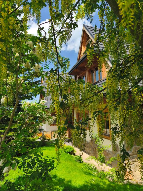 a house with a green lawn in front of it at Gontyna in Zakopane