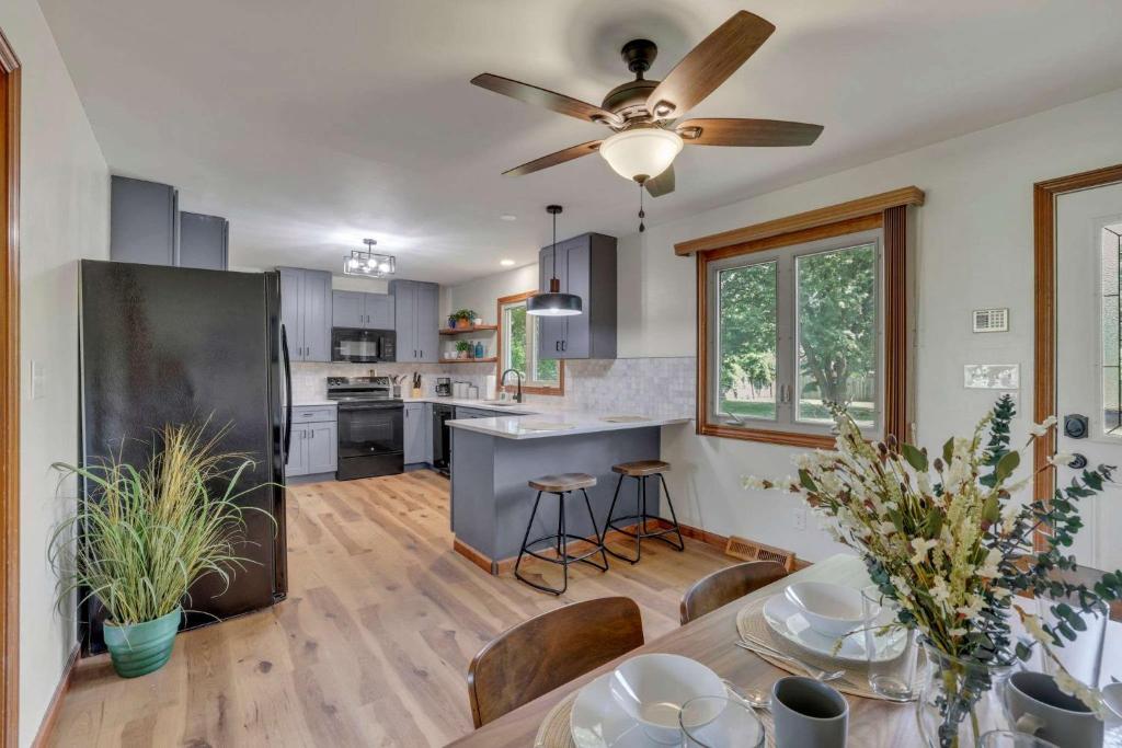 a kitchen with a table and a ceiling fan at Spacious 4BR Ranch Near Easton Perfect for Families & Work Groups in Parks Mills