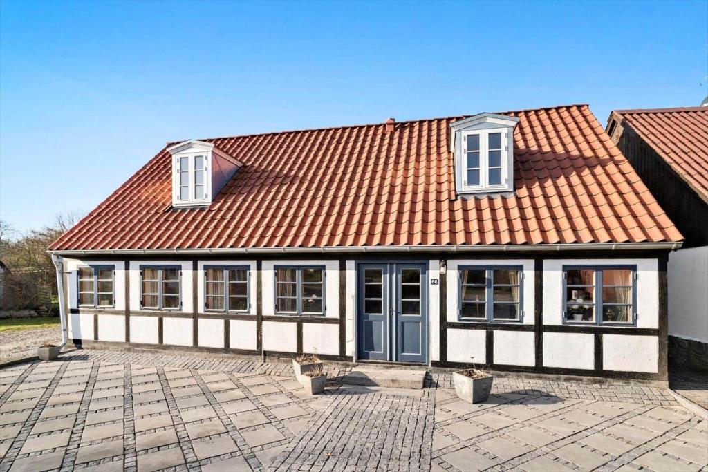 una casa con techo naranja en un patio en 20611-Samso-Brundby-Hovedgade-66, en Brundby