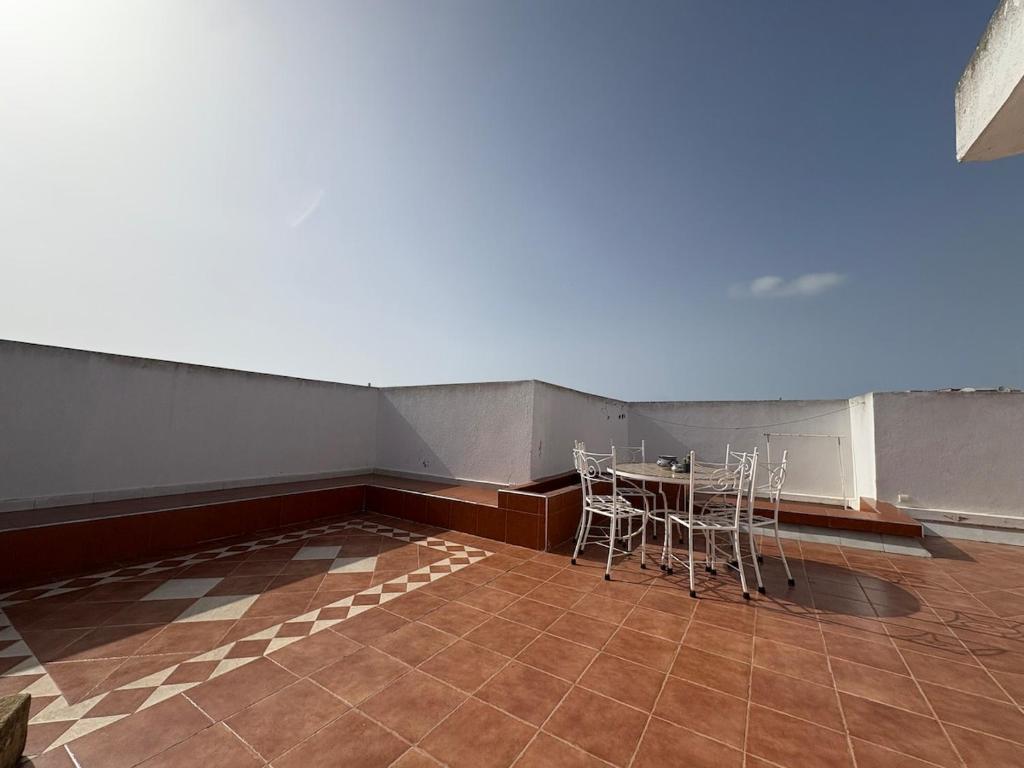 a room with a table and chairs in it at Triplex of art and serenity in Kouas