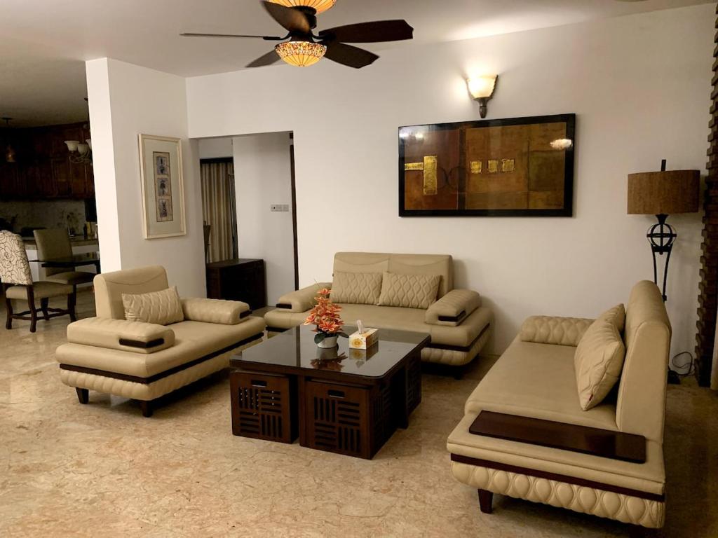 a living room with couches and a coffee table at Khonikaloy 19 4BHK in Gulshan 2 near United Hospital in Dhaka