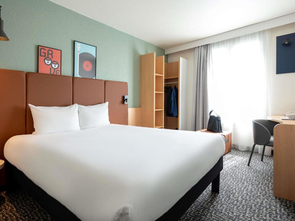 Ένα ή περισσότερα κρεβάτια σε δωμάτιο στο ibis Paris Gare de Lyon Ledru Rollin