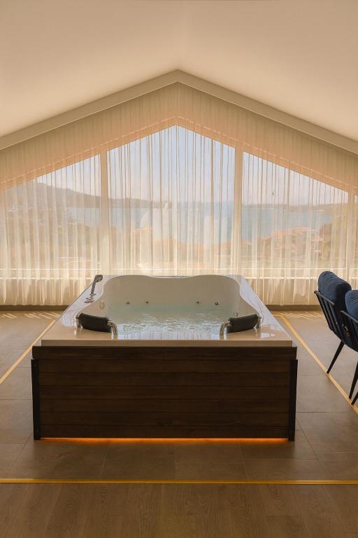 a bath tub in a room with a large window at Reflection of the Bosphorus in Istanbul