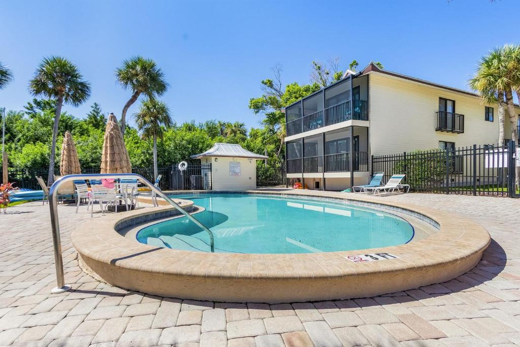 a swimming pool in a circle in front of a house at Unwind with Beach Bliss & Sunset Magic - Sunburst 113 in Punta Gorda Beach