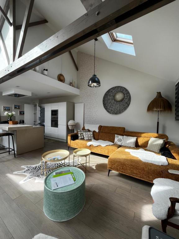 a living room with two couches and a table at Villa Le Rubis in Agon Coutainville