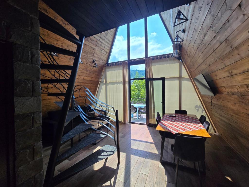 a room with a spiral staircase and a wooden wall at Dilijanyan House in Dilijan