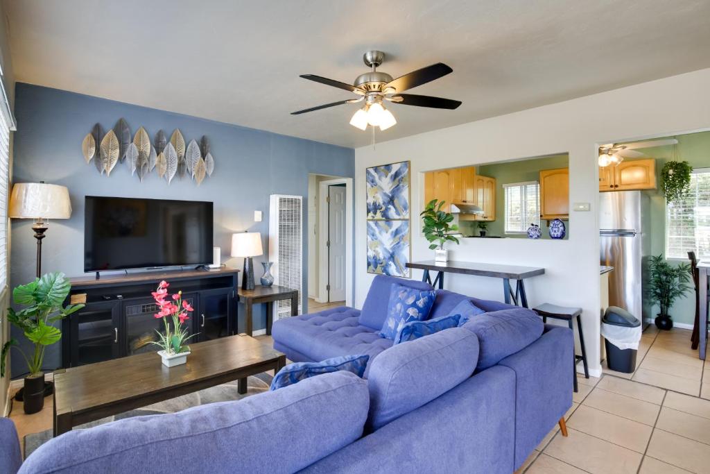 a living room with a blue couch and a tv at 4 Mi to Dtwn San Diego Cozy Getaway with Patio! in San Diego