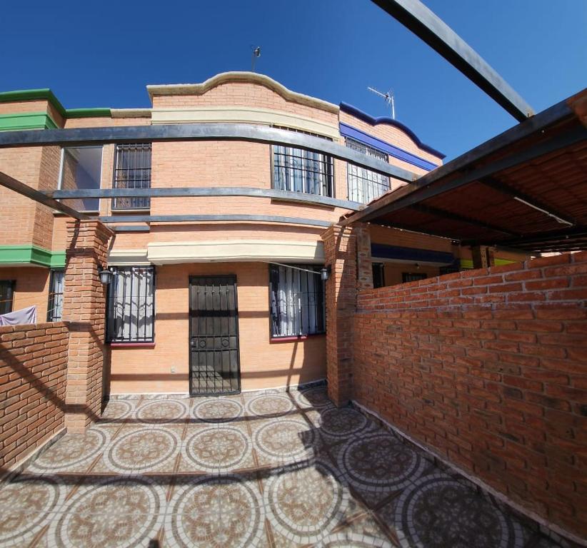 a brick building with a gate in front of it at Hermosa Casa en Guanajuato Capital in Yerbabuena