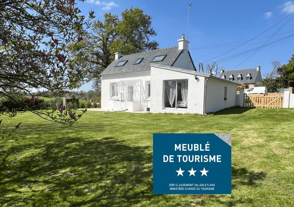 a house for sale with a sign in front of it at Chez Josie, cottage en Bretagne in Bannalec