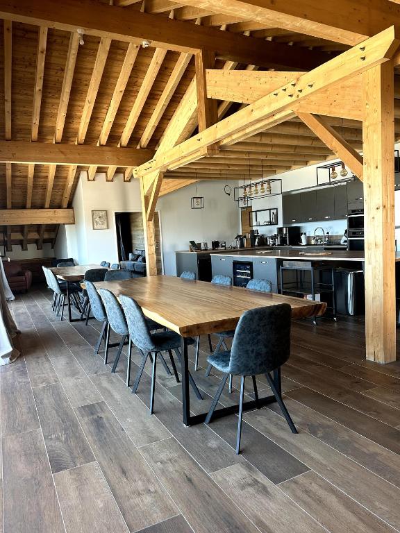 a large wooden table and chairs in a kitchen at Appartement Chalet Des Lacs in L'Alpe-d'Huez