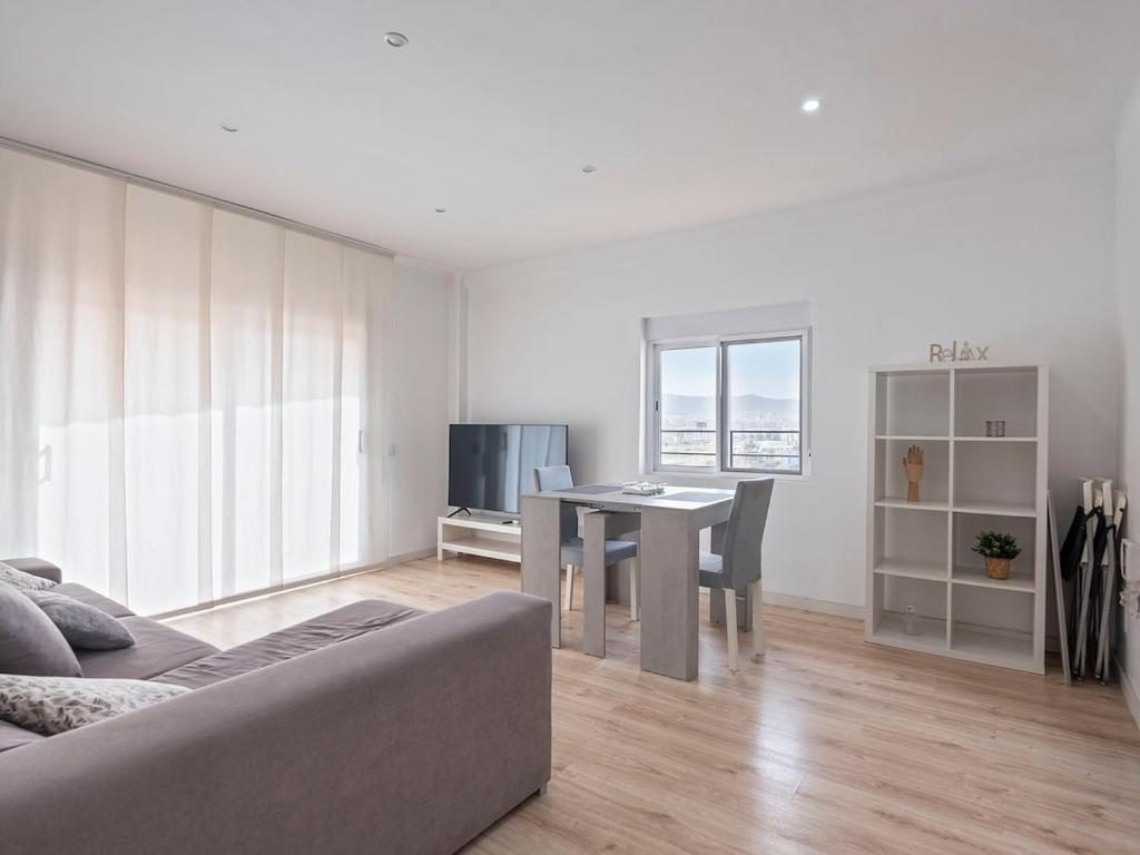 ein Wohnzimmer mit Tisch und Couch in der Unterkunft Playa, Port Fórum y BCN centro a 10 min - Apartamento con Vistas in Sant Adria de Besos