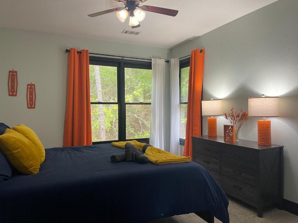 a bedroom with a blue bed and a window at Tranquil Mountain Lodge Escape Near Carters Lake in Ranger