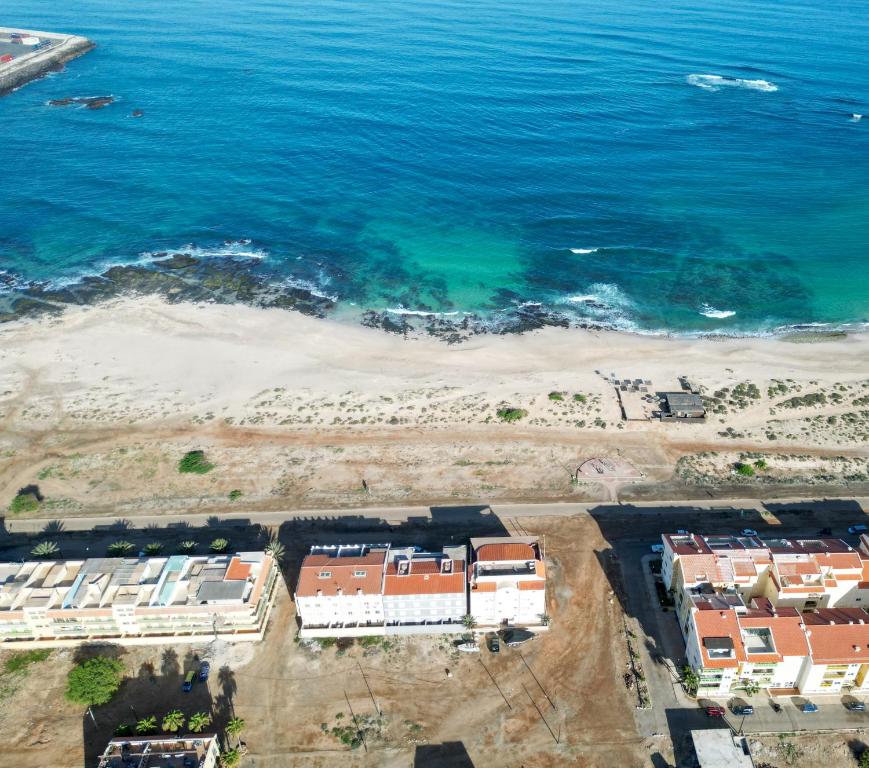 an aerial view of a beach with buildings and the ocean at I LOVE BOA VISTA - Seafront Apartments in Sal Rei