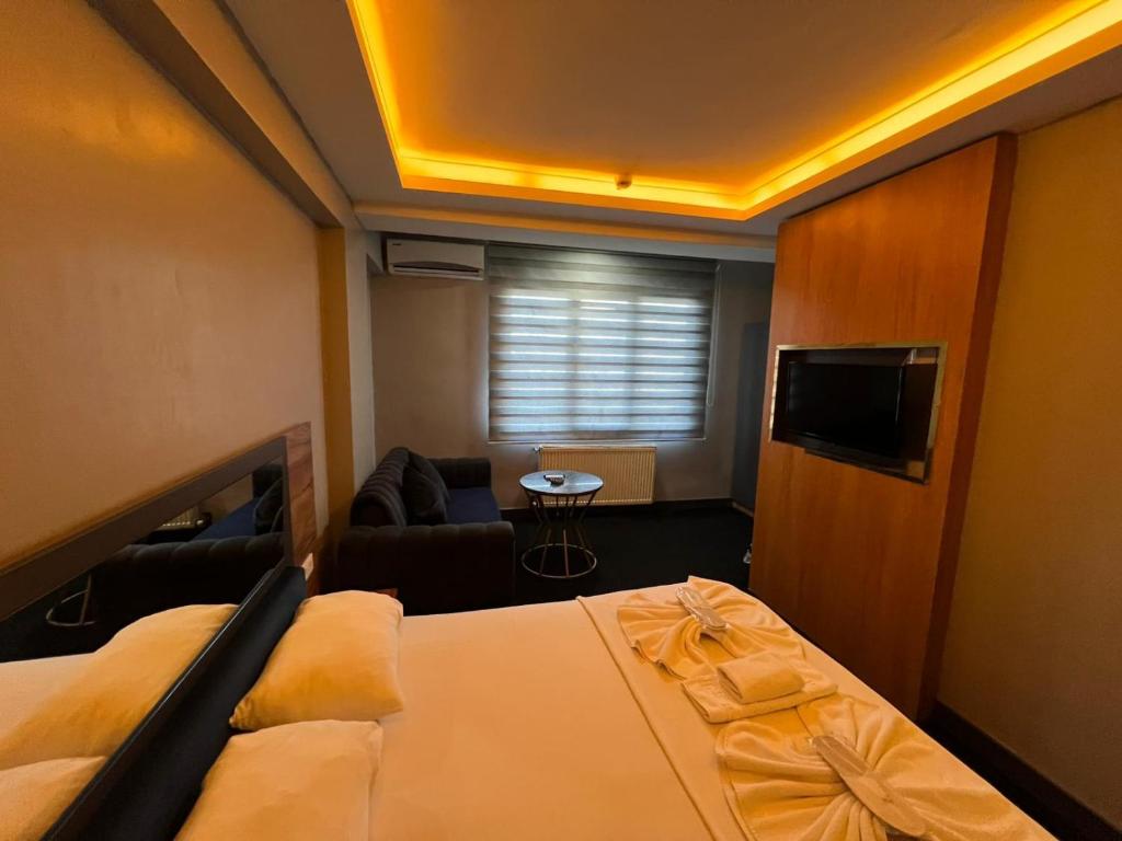 a hotel room with a bed and a living room at NEAR SUITES in Istanbul