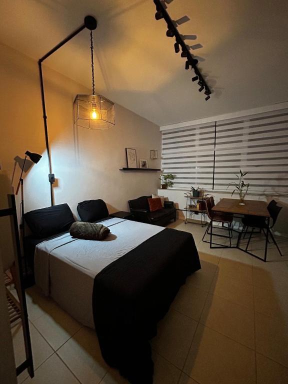 a bedroom with a large bed and a dining room at Loft com área de trabalho isolado - Centro do Rio de Janeiro in Rio de Janeiro