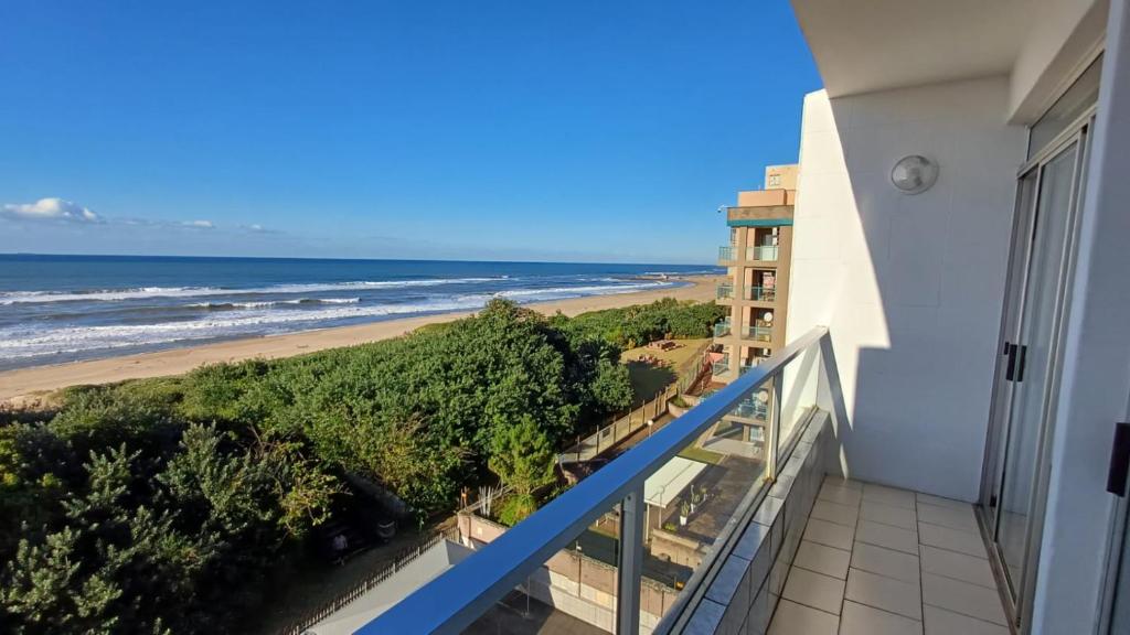 a balcony with a view of the beach at Toti Cabanas in Amanzimtoti