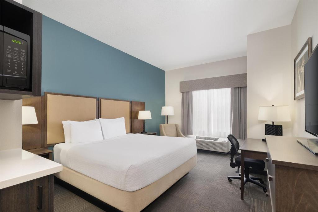 a hotel room with a bed and a desk at Best Western Plus Frontier Inn in Cheyenne