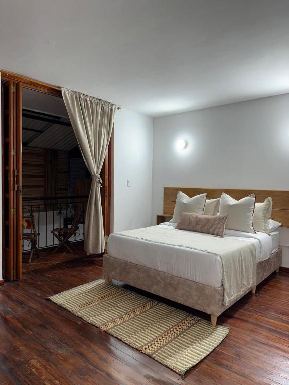 a bedroom with a large bed and a window at Casa Alma Hospedaje in Mocoa