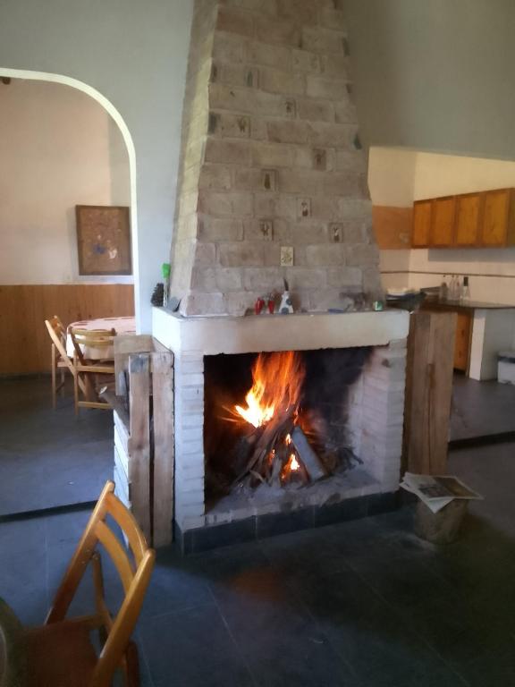 a fireplace in a living room with a fire at Casa en el campo in Montevideo