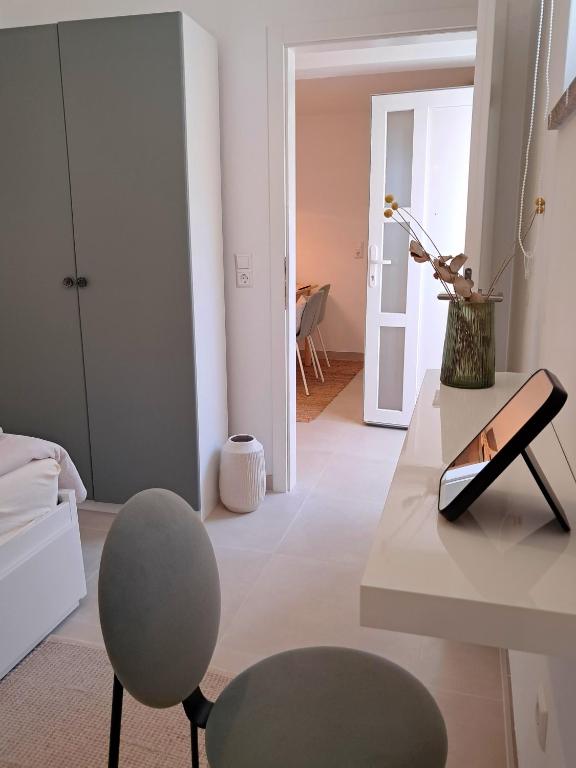a living room with a table and a chair at Olive Apartment Rovinj in Rovinj
