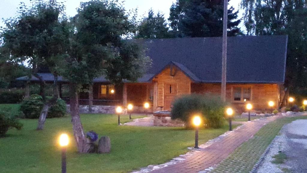 a house with lights in the yard at night at Erlendi Kodumajutus in Pärnu