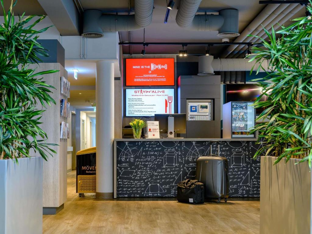 a lobby of a building with potted plants at ibis Köln Frechen in Cologne