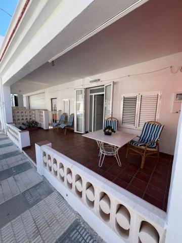 a balcony with a table and chairs on a house at Isla Sicilia in Oliva