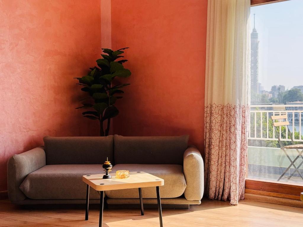 Wujoud - 5 Bedroom Apartment في القاهرة: غرفة معيشة بها أريكة وطاولة