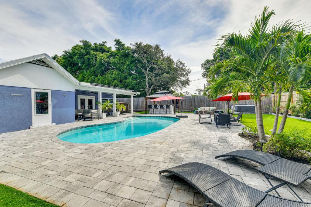 a backyard with a swimming pool and patio furniture at Backyard with Pool and Games! Family Home in Bradenton in Palma Sola Park