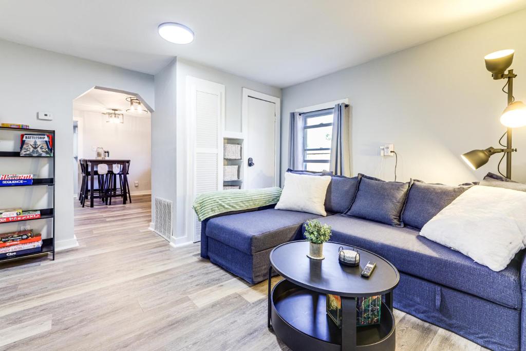 a living room with a blue couch and a table at Walk and Bike Great Miami River Trail Dayton Home in Dayton