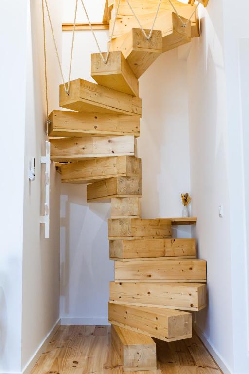 a staircase made out of wood in a room at Casas do Freixial - Casa das Flores in Fundão